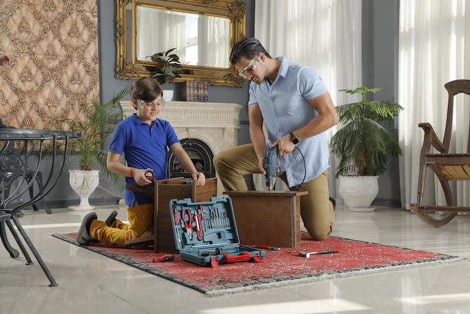 Tools are being used for a DIY project by a family