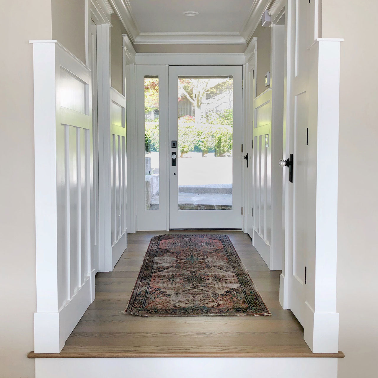 hallway with black and crystal door hardware